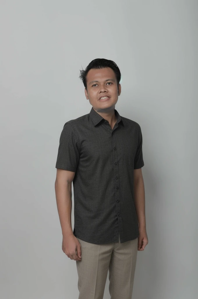 Muhammad Naufal Kateni in a dark short-sleeved shirt against a grey studio wall